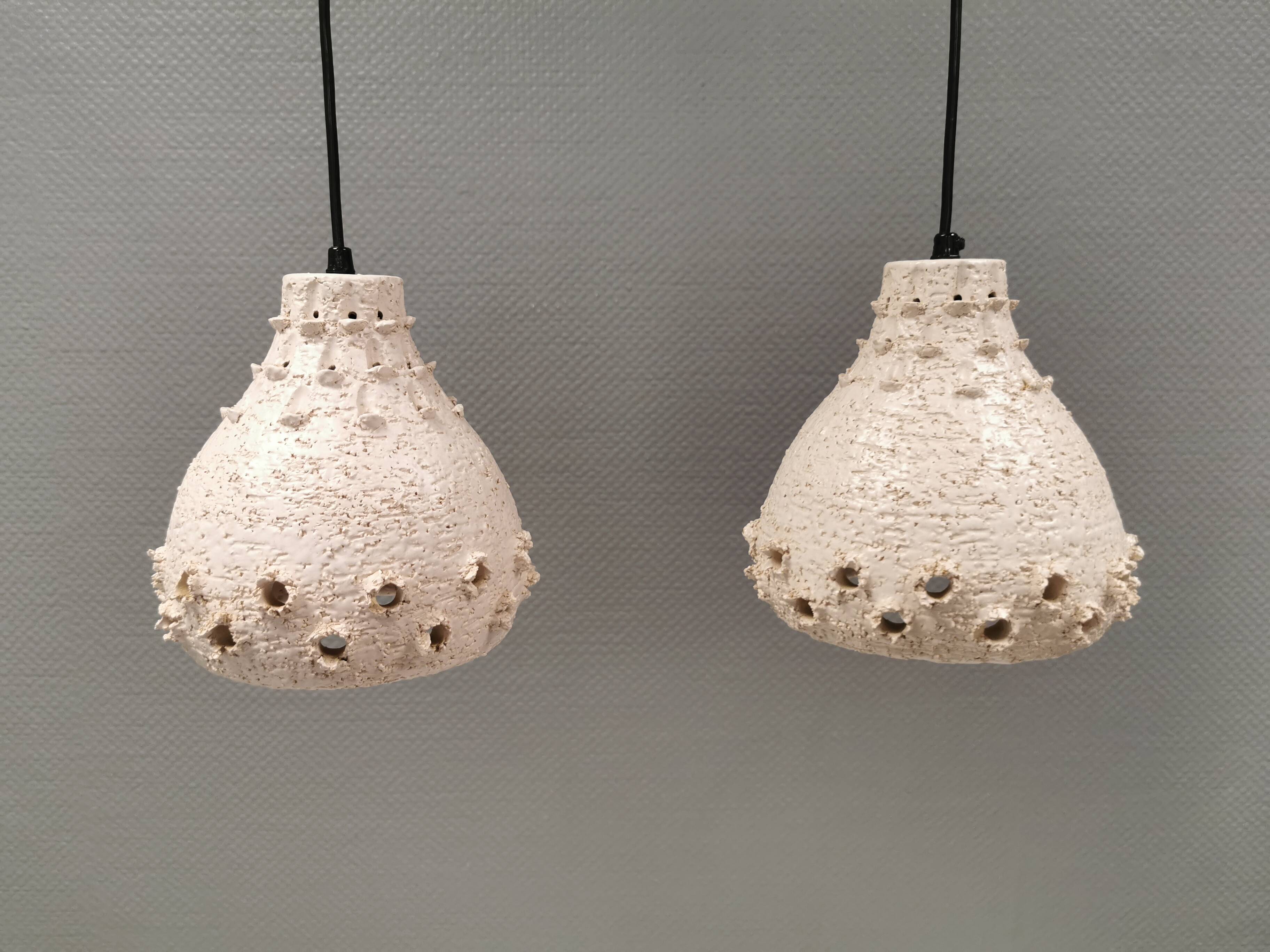 Two ceramic hanging lamps, in creamy white color, looking almost like coral