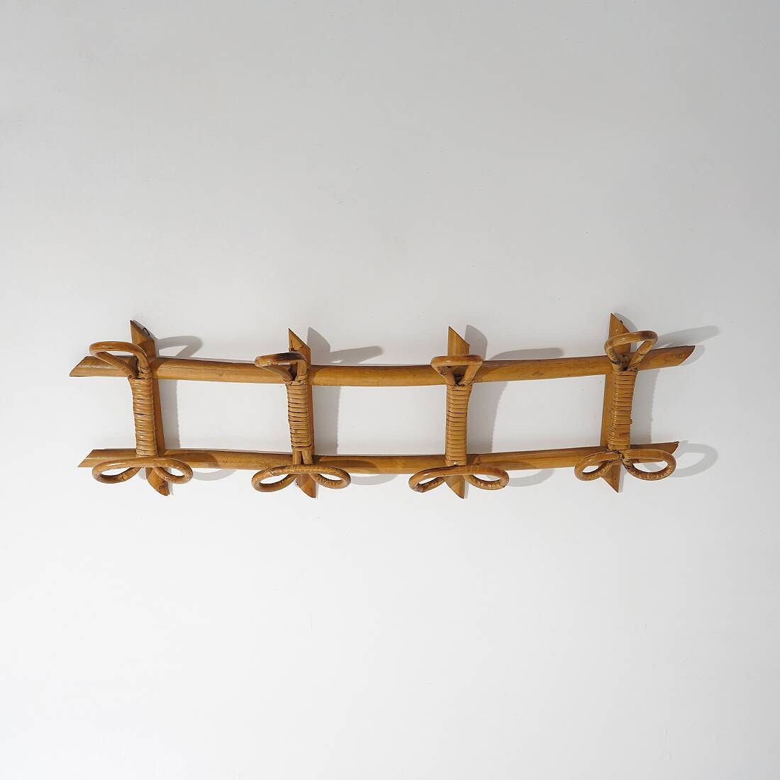 Wall coat rack in rattan and woven wicker, 1960s.