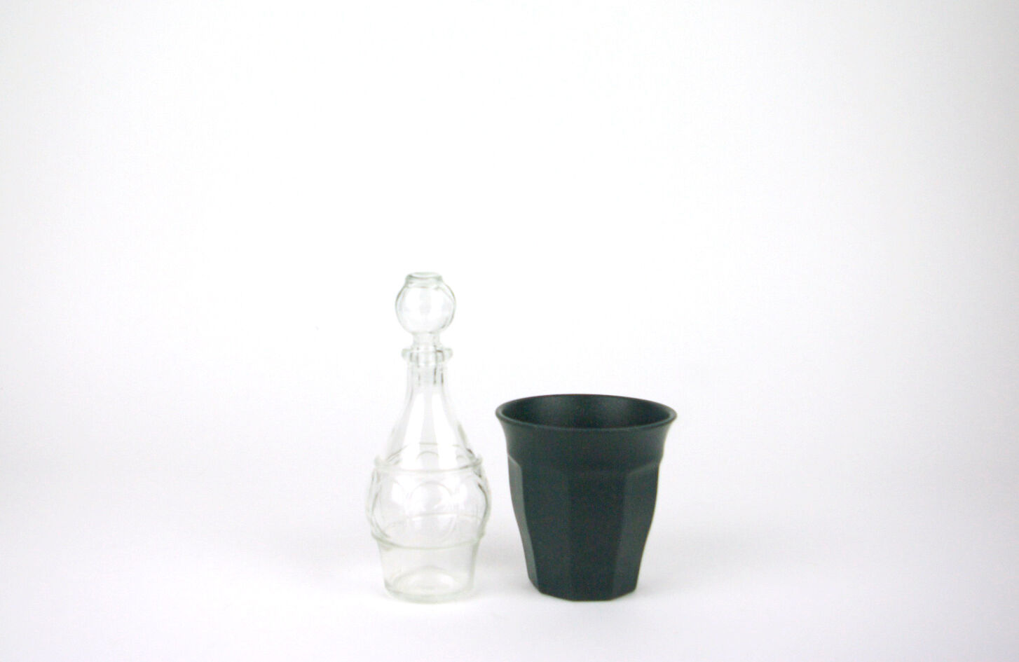 Small bottle with a glass cap with geometric patterns