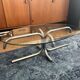 Oval glass coffee table with chrome legs, vintage 70s design.
