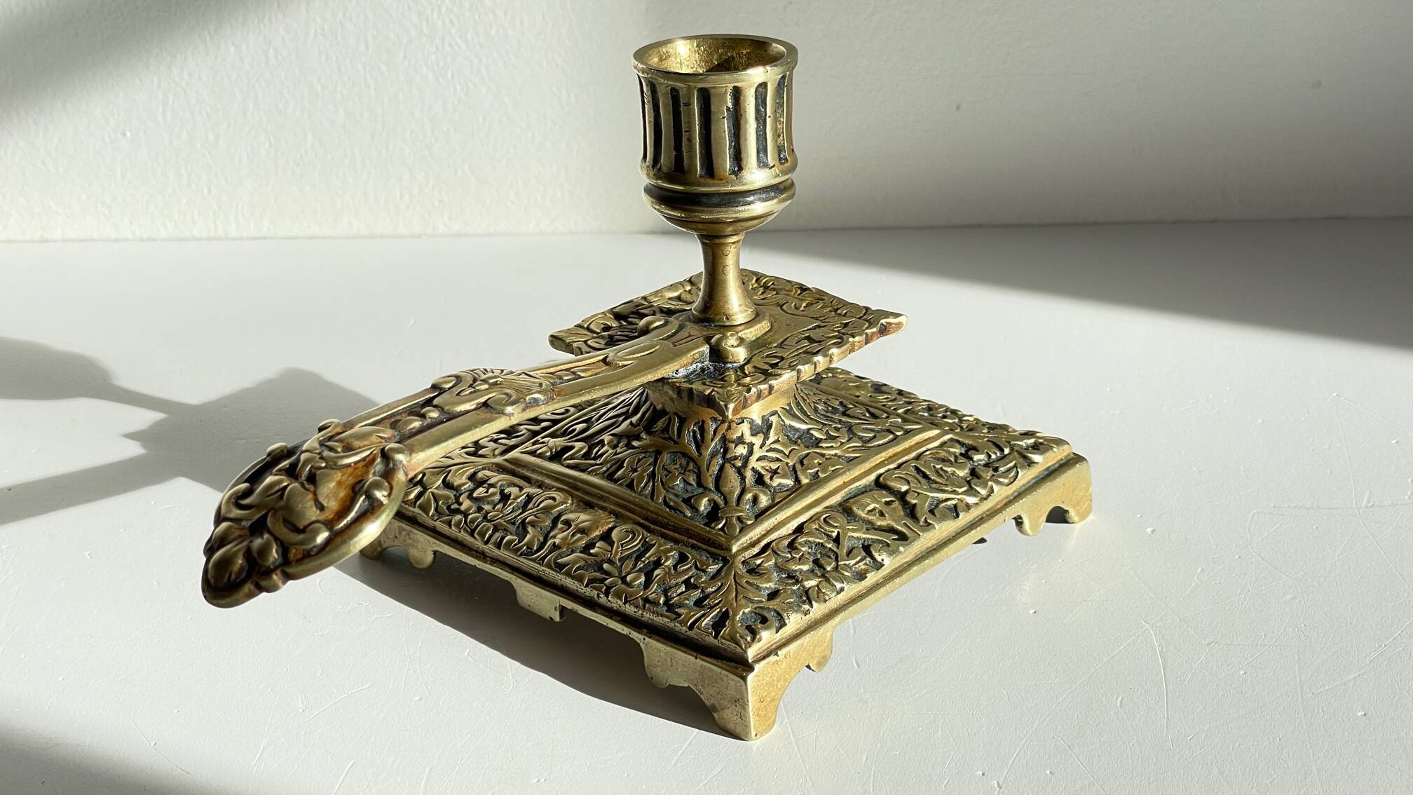 Patterned solid bronze hand candle holder