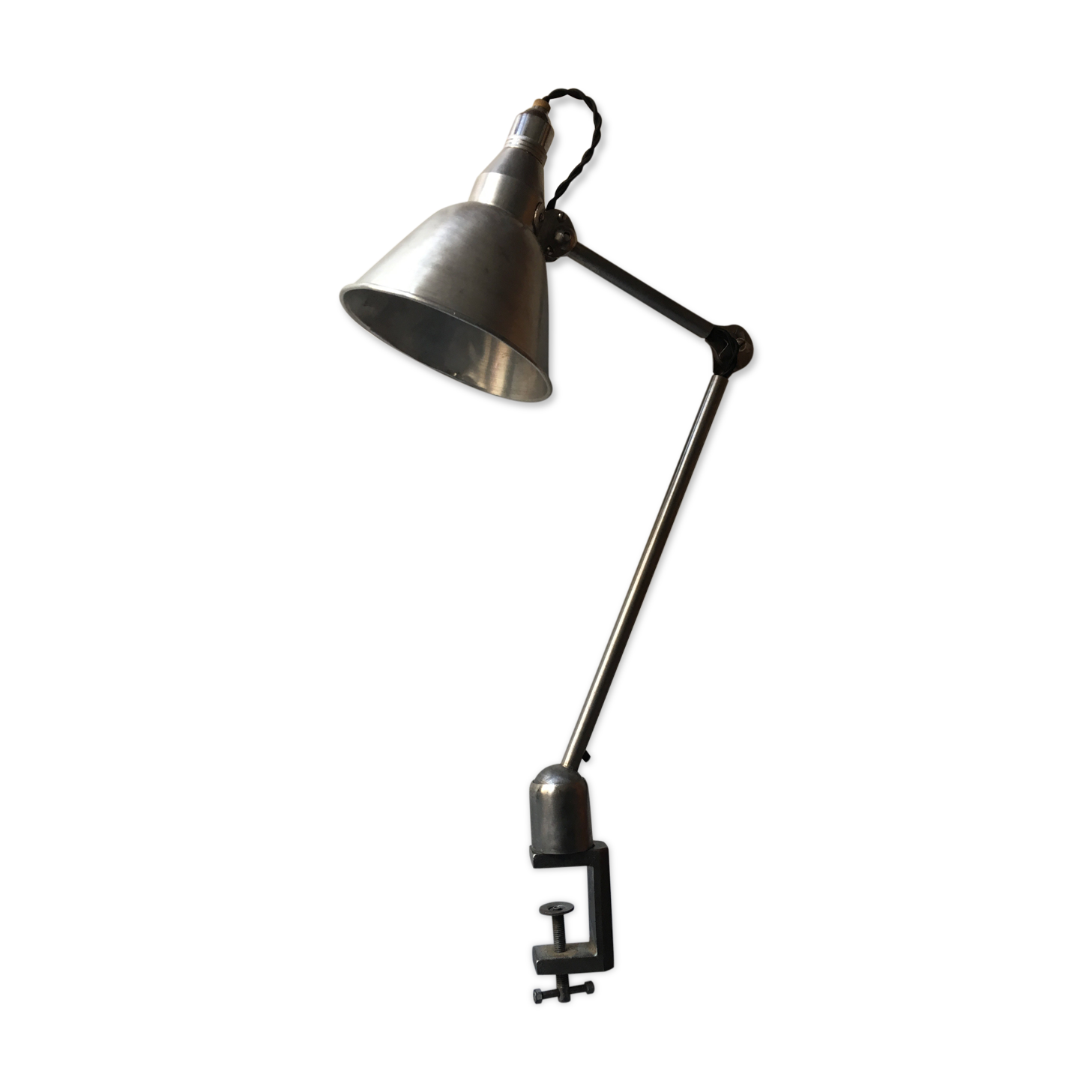 Old industrial lamp has vise 'mazda '.