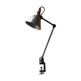 Old industrial lamp has vise 'mazda '.