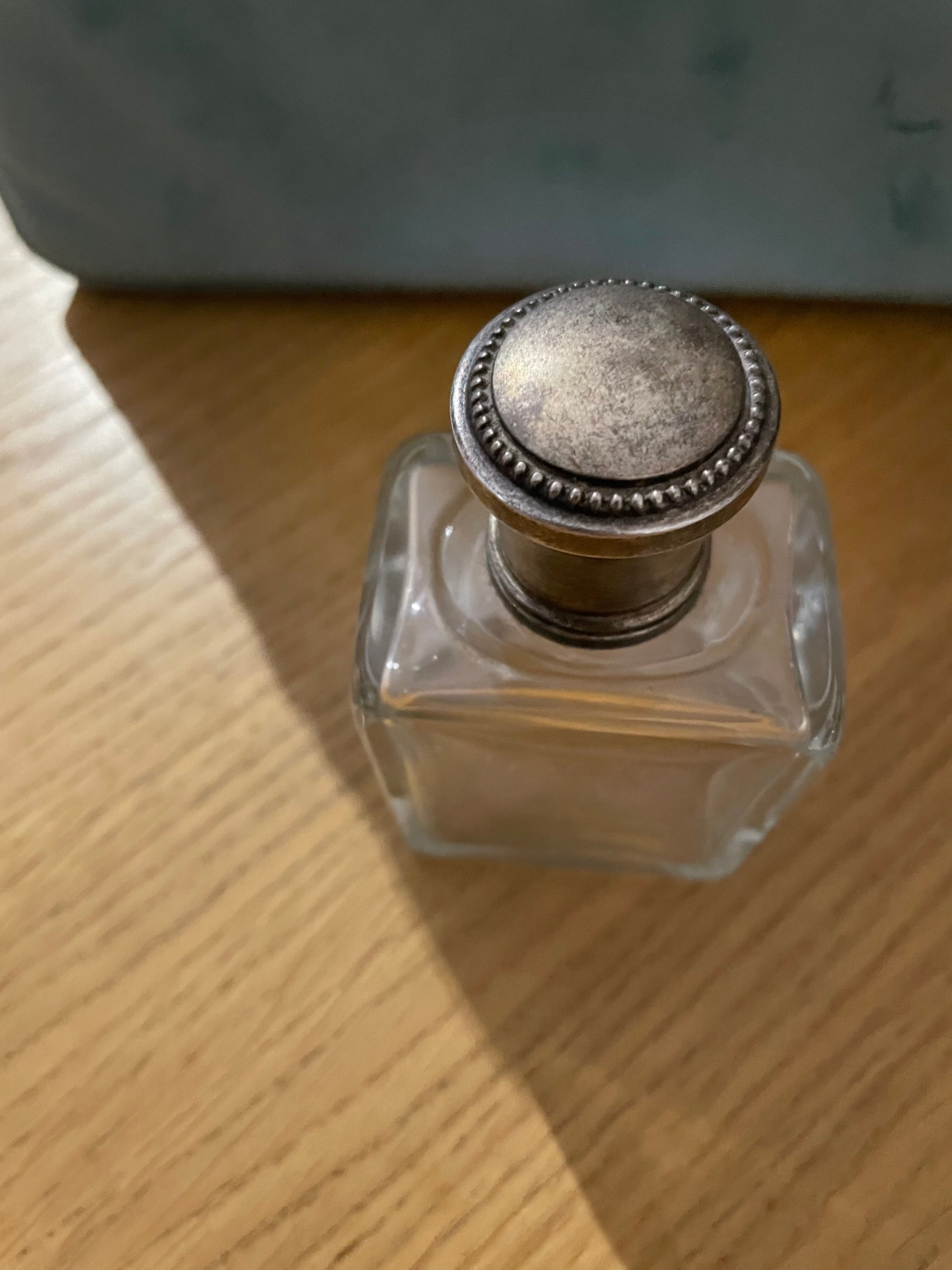 Old perfume bottle silver metal cap