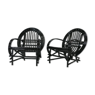 Pair of black lacquered rattan armchairs. France, cira 1960.
