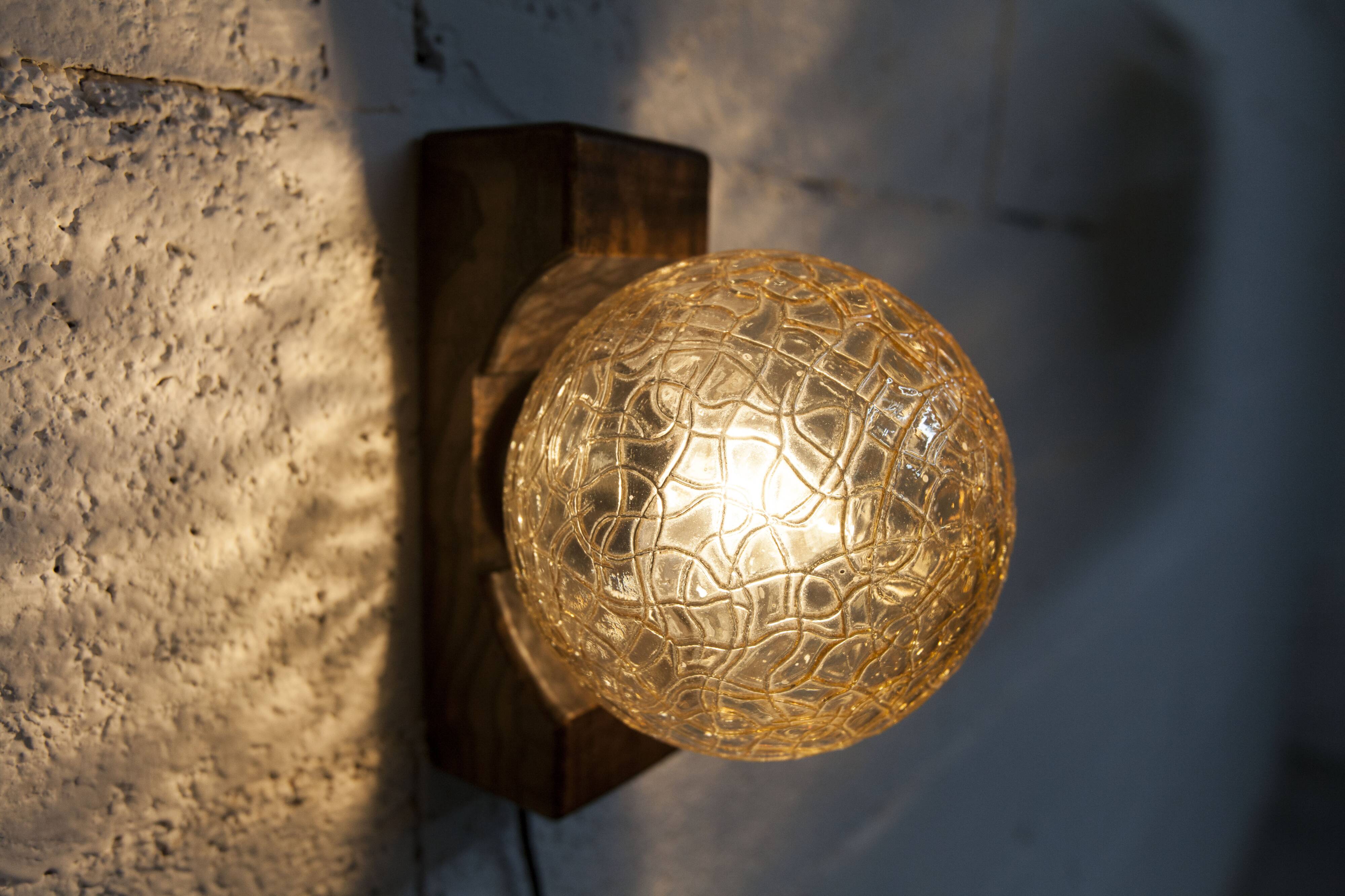 1960s ball wall light in dark wood and amber glass