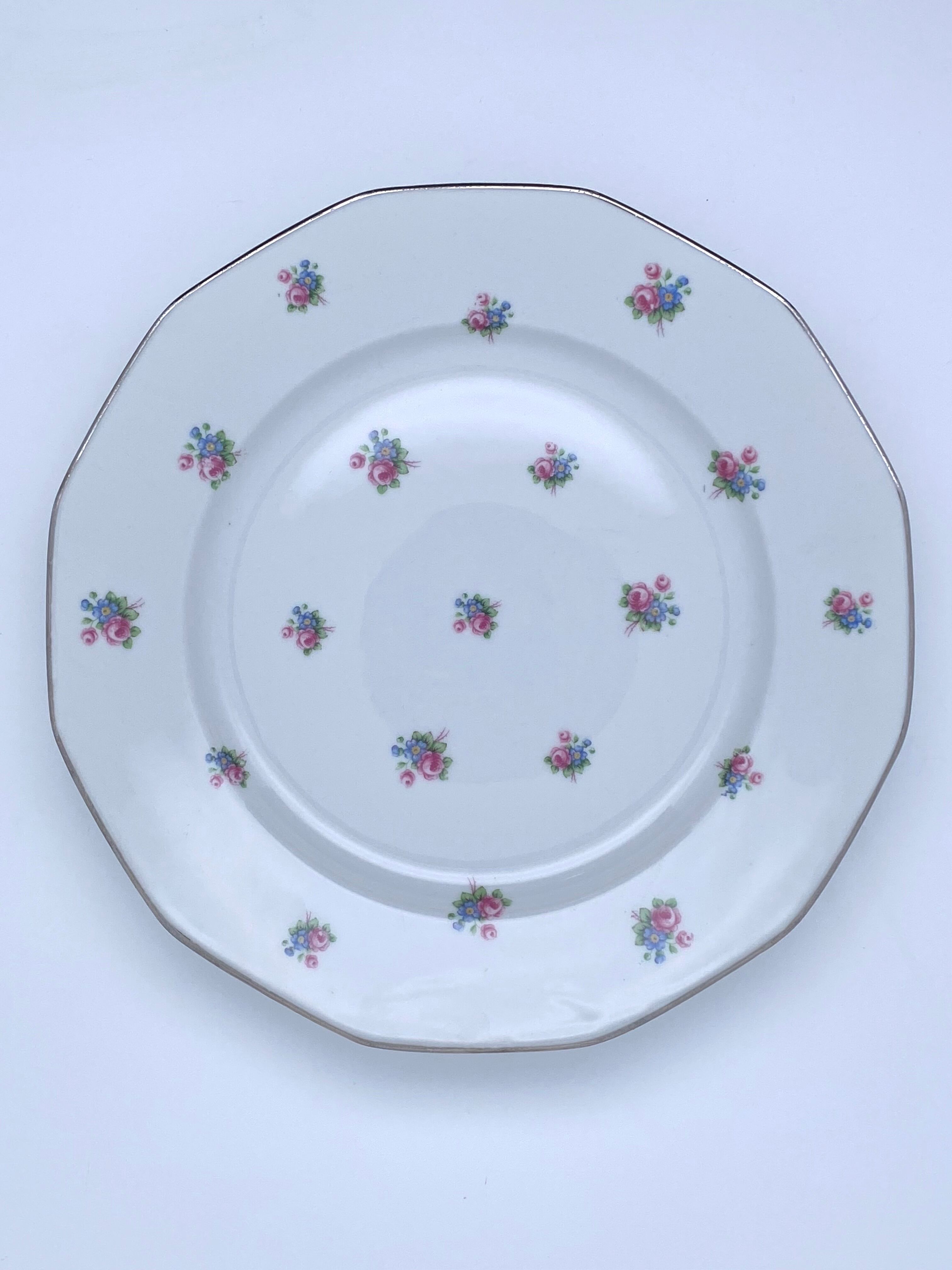 Porcelain serving dishes with small flowers and silver edging and