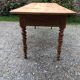 Antique Louis Philippe style farm table in solid cherry wood with 2 drawers and turned base.