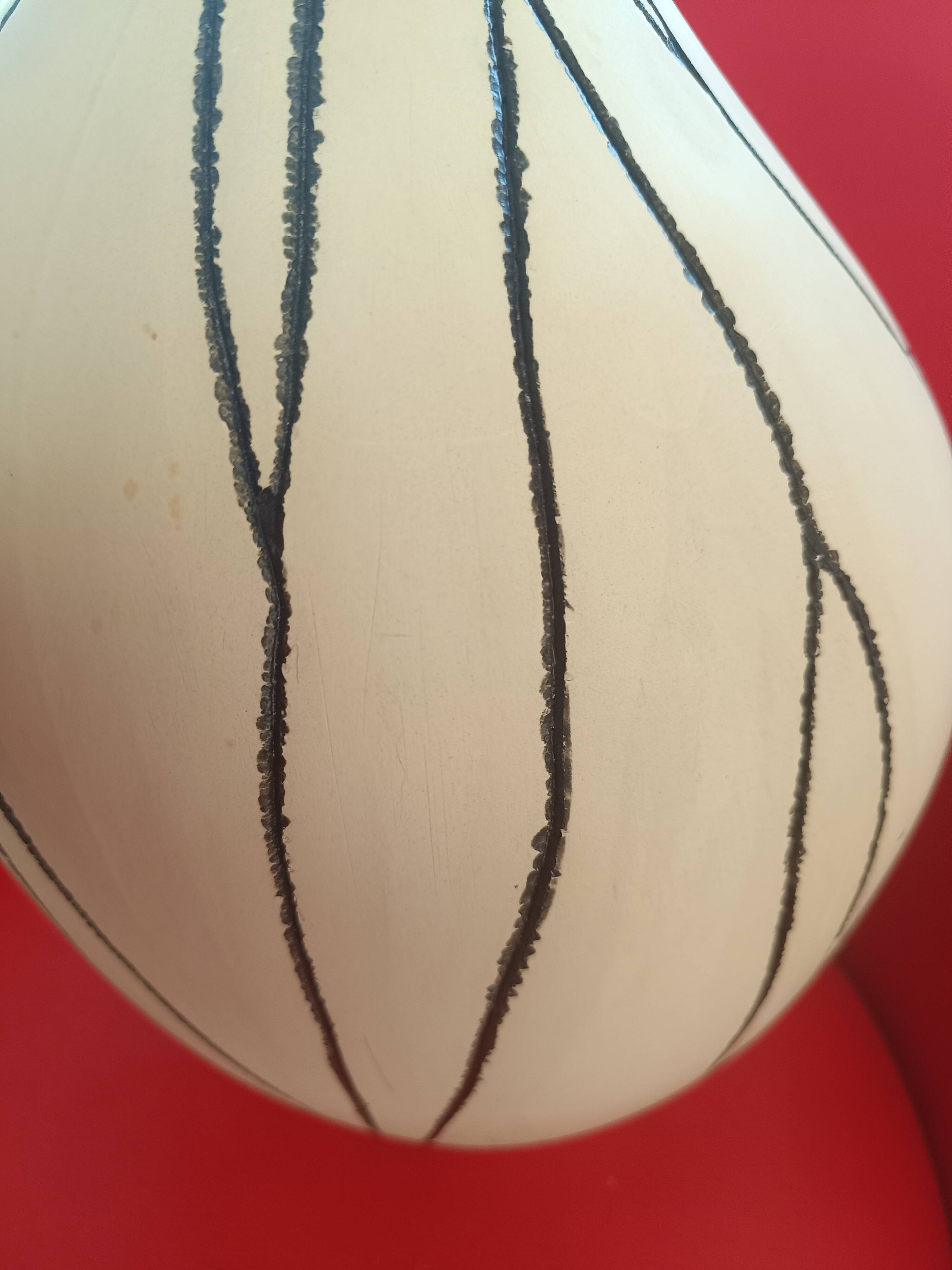 Designer vase in white ceramic with enamelled black stripes.