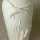 Thick white porcelain vase with relief decoration of a flying duck.