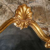 Large gilded mirror Louis XV style with shell.