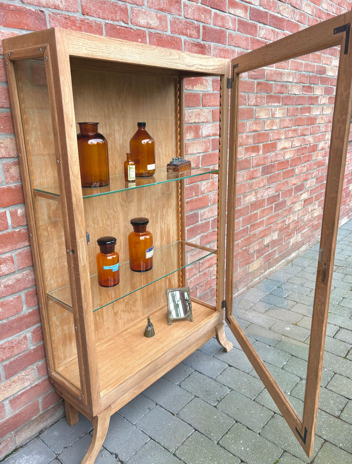 Restored antique oak display cabinet with glass shelves.