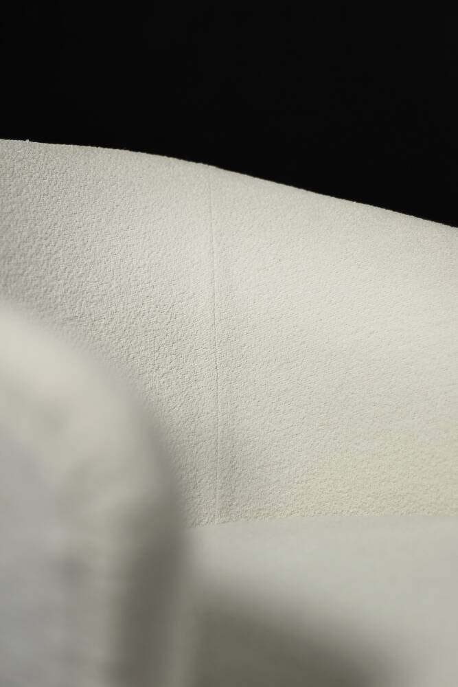 Low oak armchair with modern mid-century Scandinavian fabric and rounded backrest, 1960s.