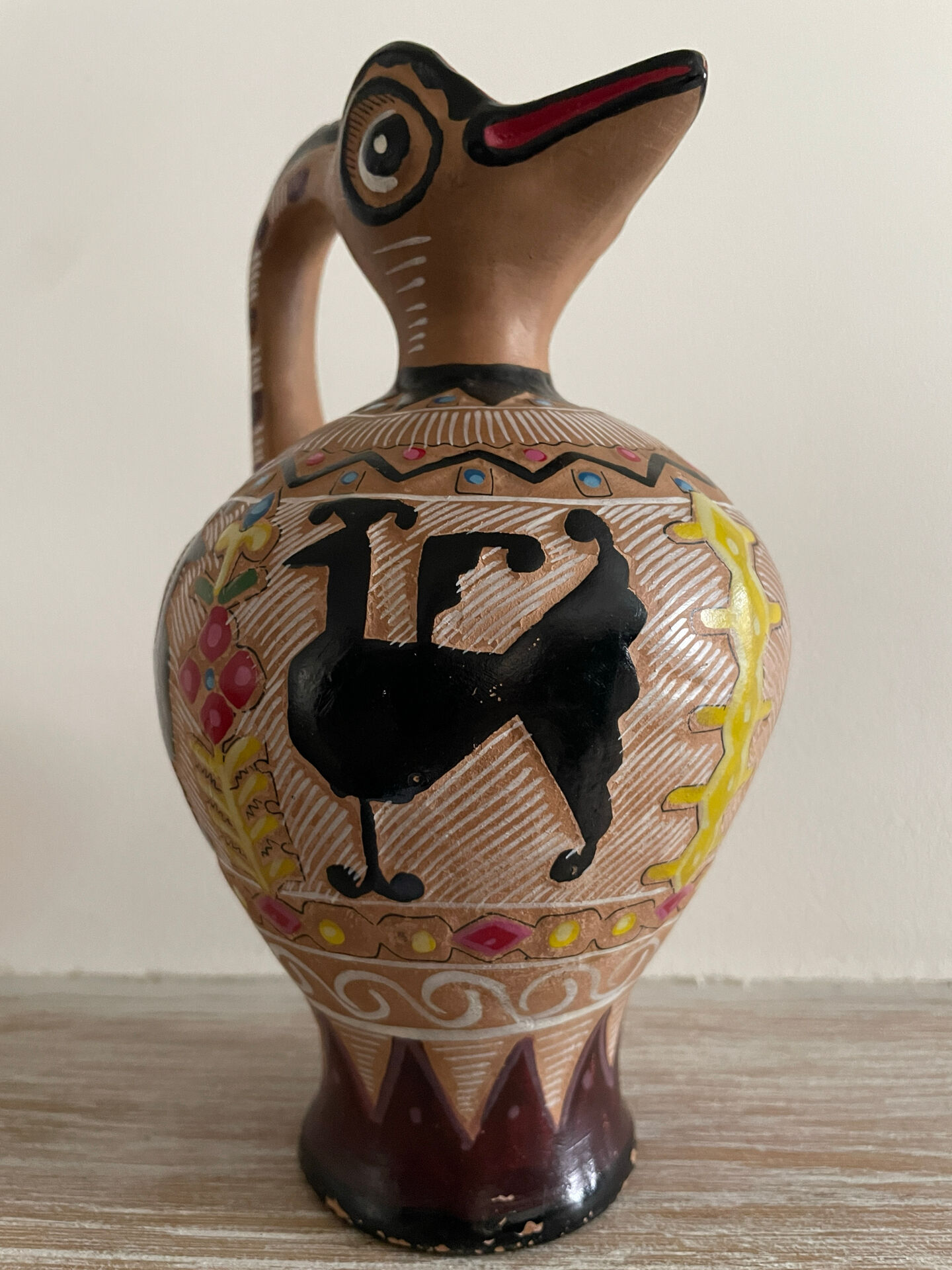 Clay pitcher with a bird head