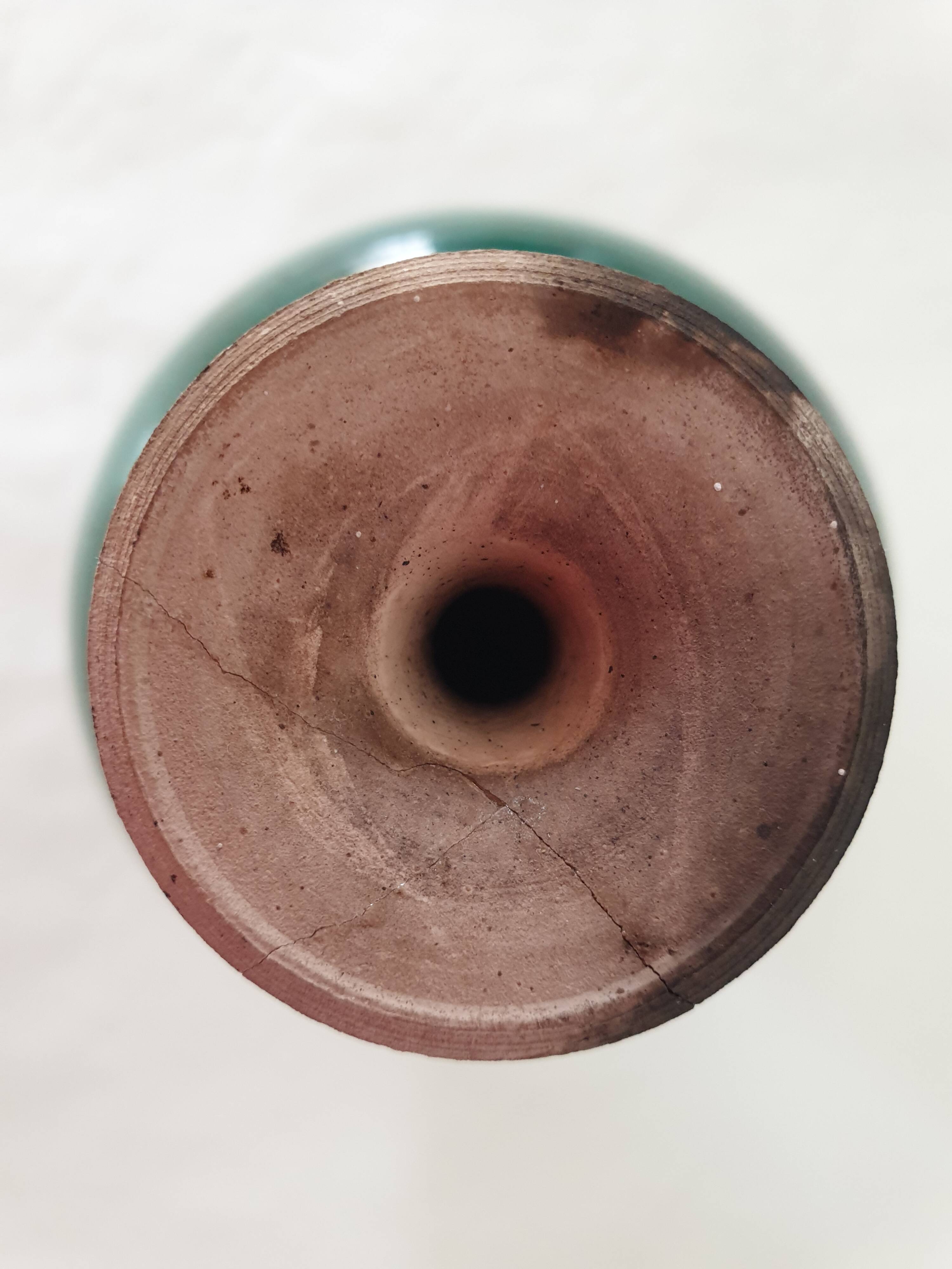 Green pot-bellied ceramic vase with foot and high, narrow neck in signed raku