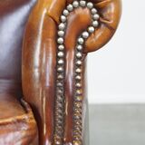 Comfortable, elegant, stately wing chair made of sheepskin in a beautiful warm color