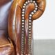 Comfortable, elegant, stately wing chair made of sheepskin in a beautiful warm color