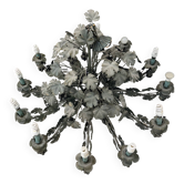 Old-fashioned country-style chandelier with virgin vine and bunch of grapes.
