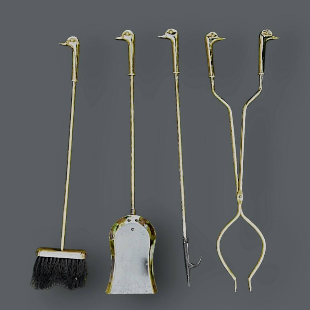 Antique fireplace tool in gilded zamak with duck head designs.