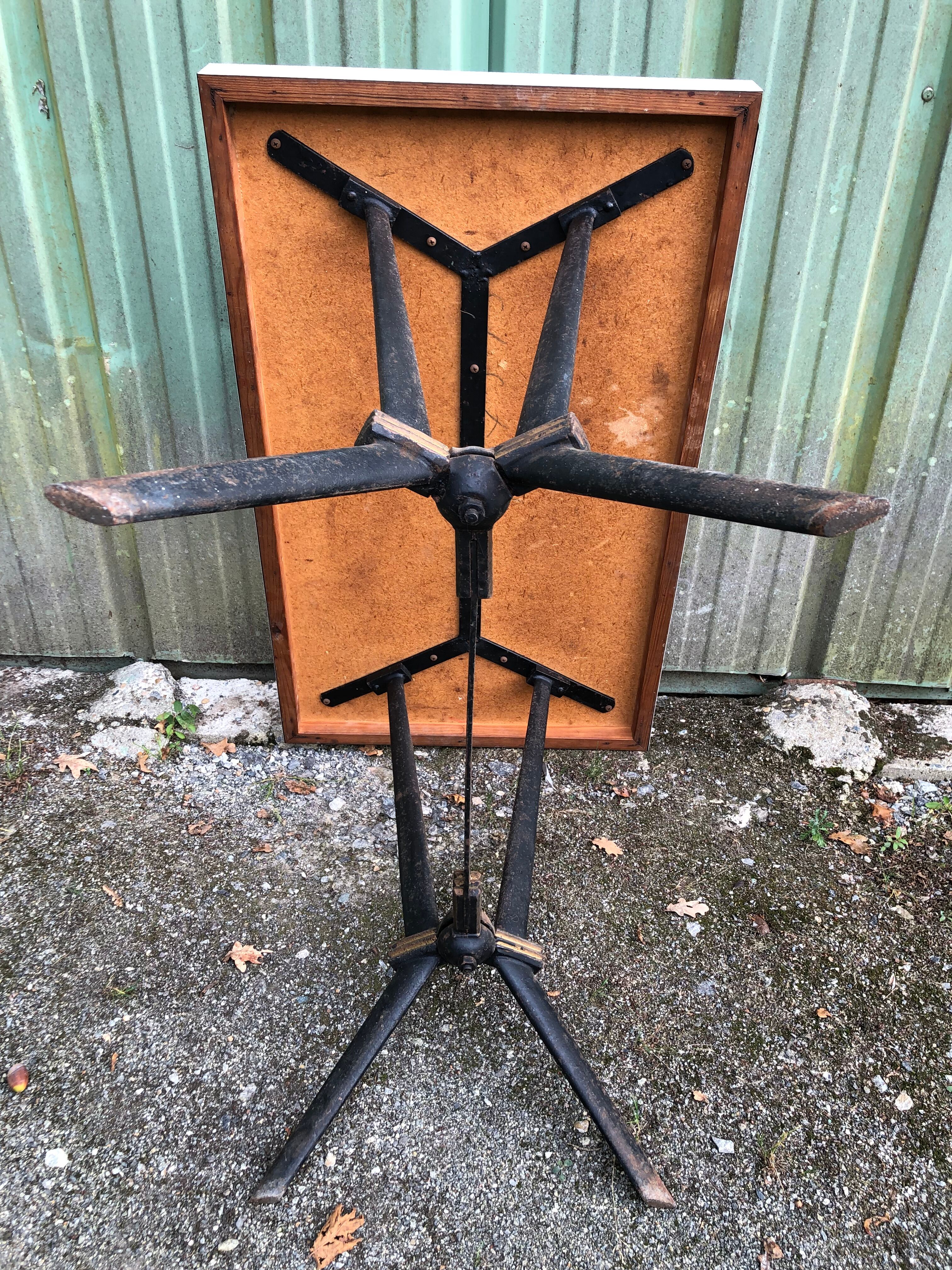 Vintage bistro table with an Art Deco style cast iron base and Formica top.
