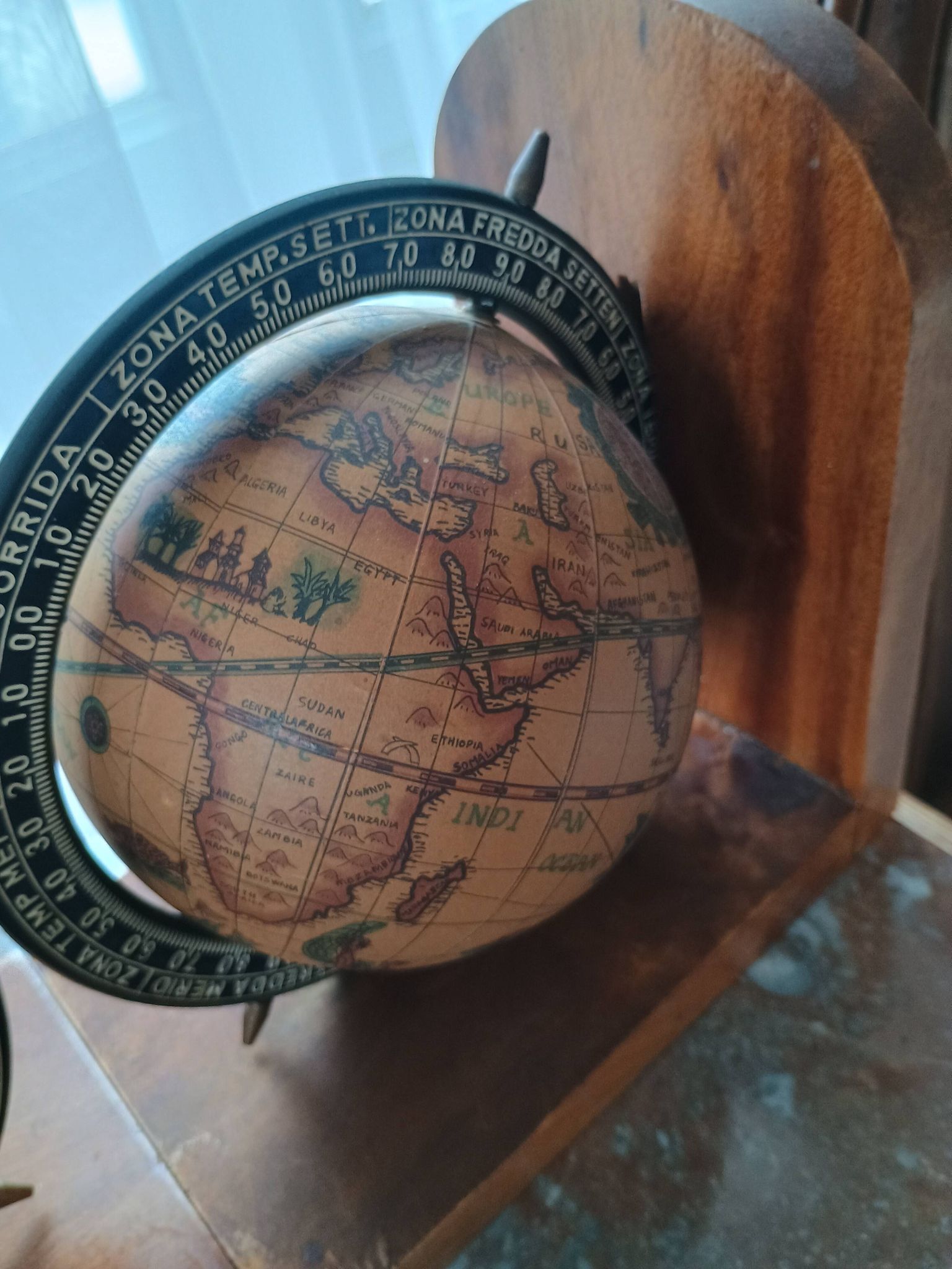 Pair of vintage bookends with rotating terrestrial globes on wooden bases in Spain