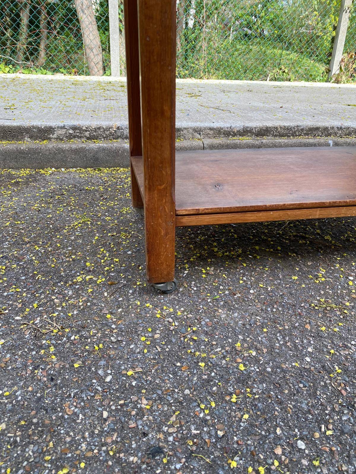 Vintage farmhouse dessert trolley on wheels made of solid wood from the 19th century.