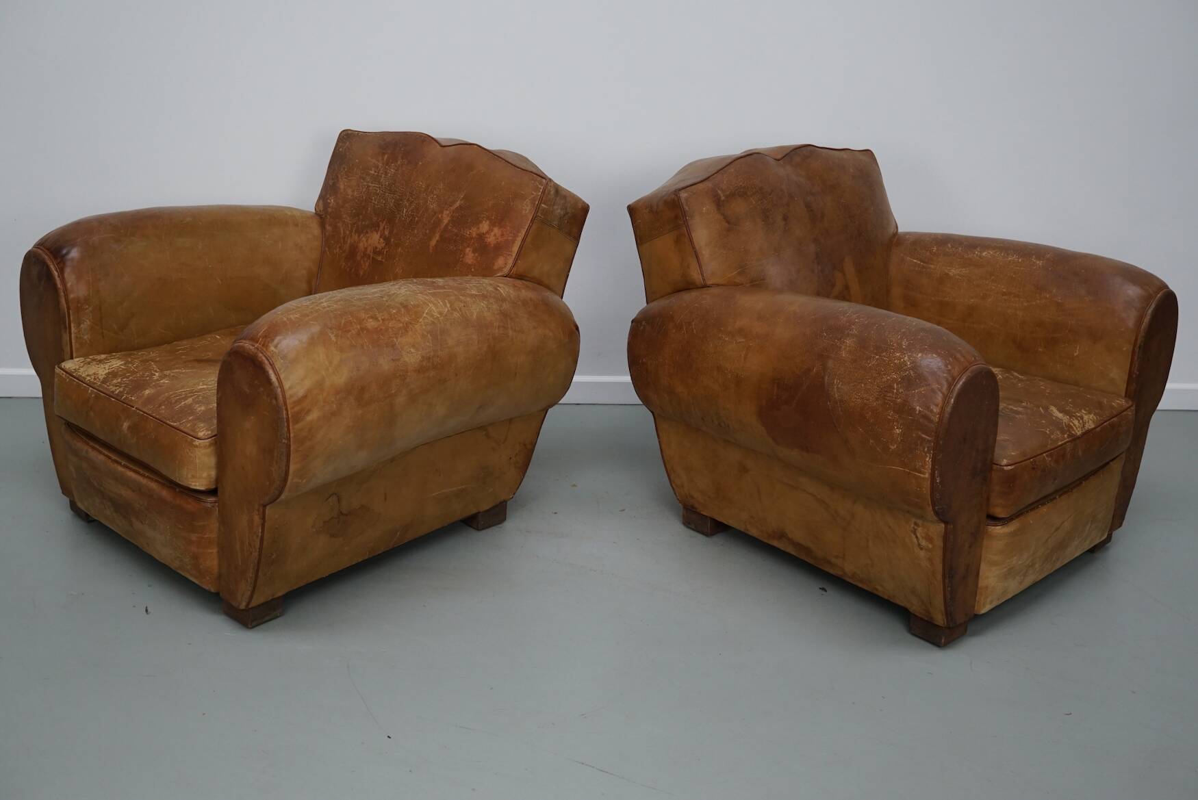Pair of French club chairs with moustache back in cognac leather, 1940s