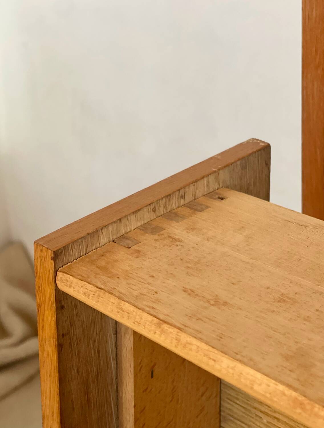 Vintage 1960s chest of drawers with covered handles.
