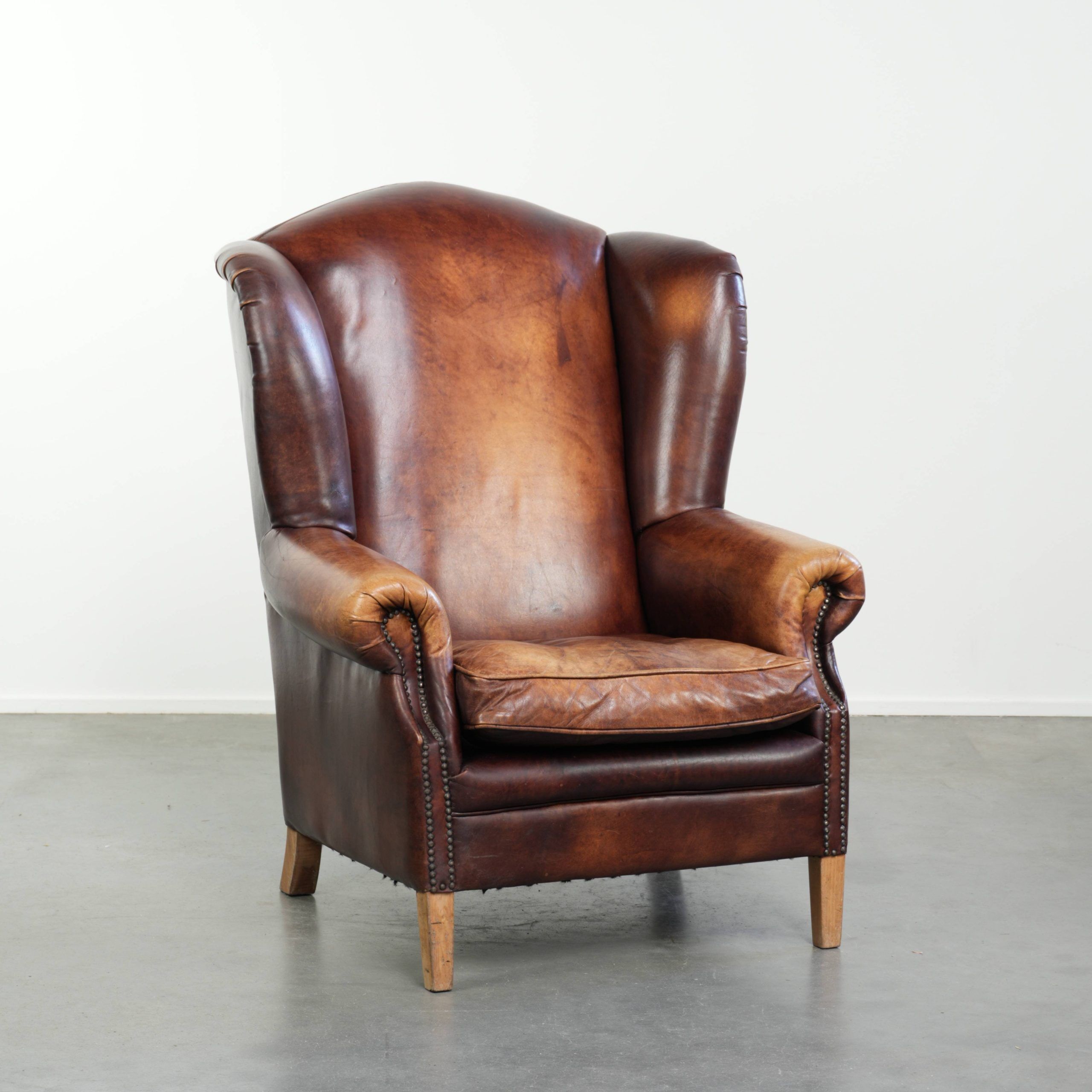 Comfortable cowhide wingback armchair in English style