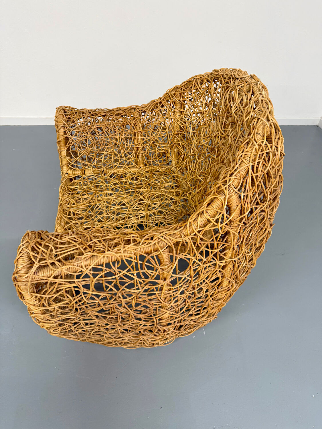 Sculptural woven rattan armchair, organic design from the 1970s.