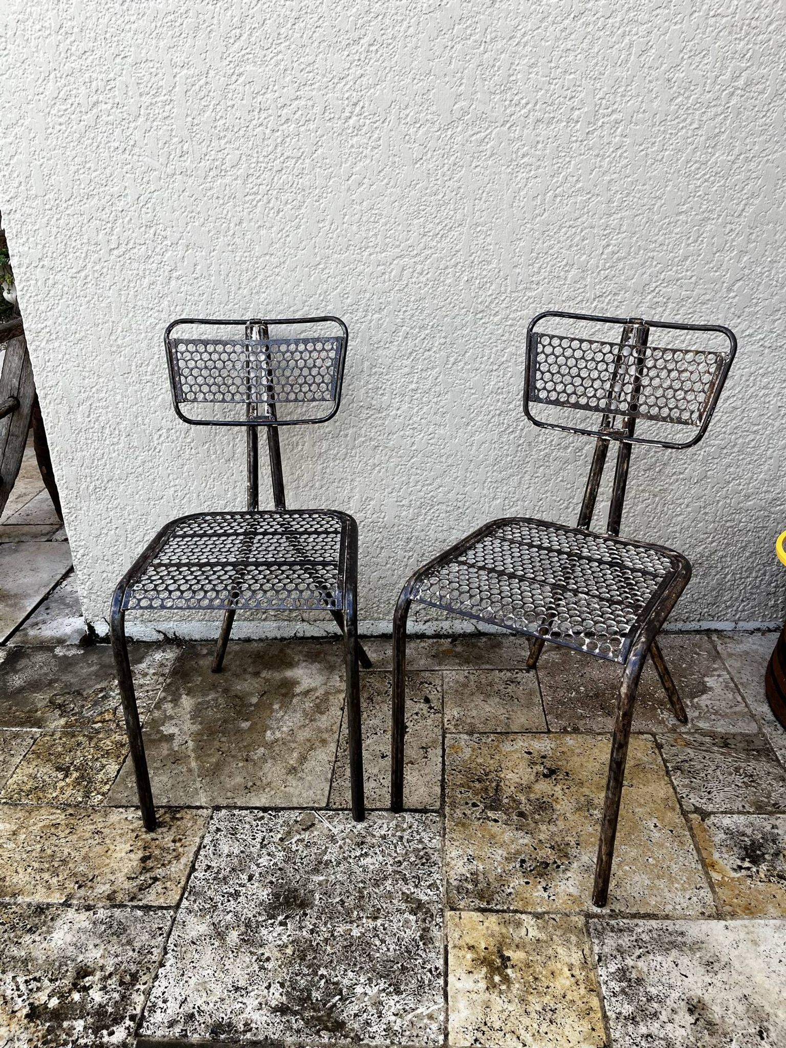 Pairs of perforated metal chairs by René Malaval