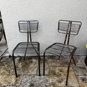 Pairs of perforated metal chairs by René Malaval
