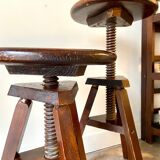 2 tripod stools with dark wood screws