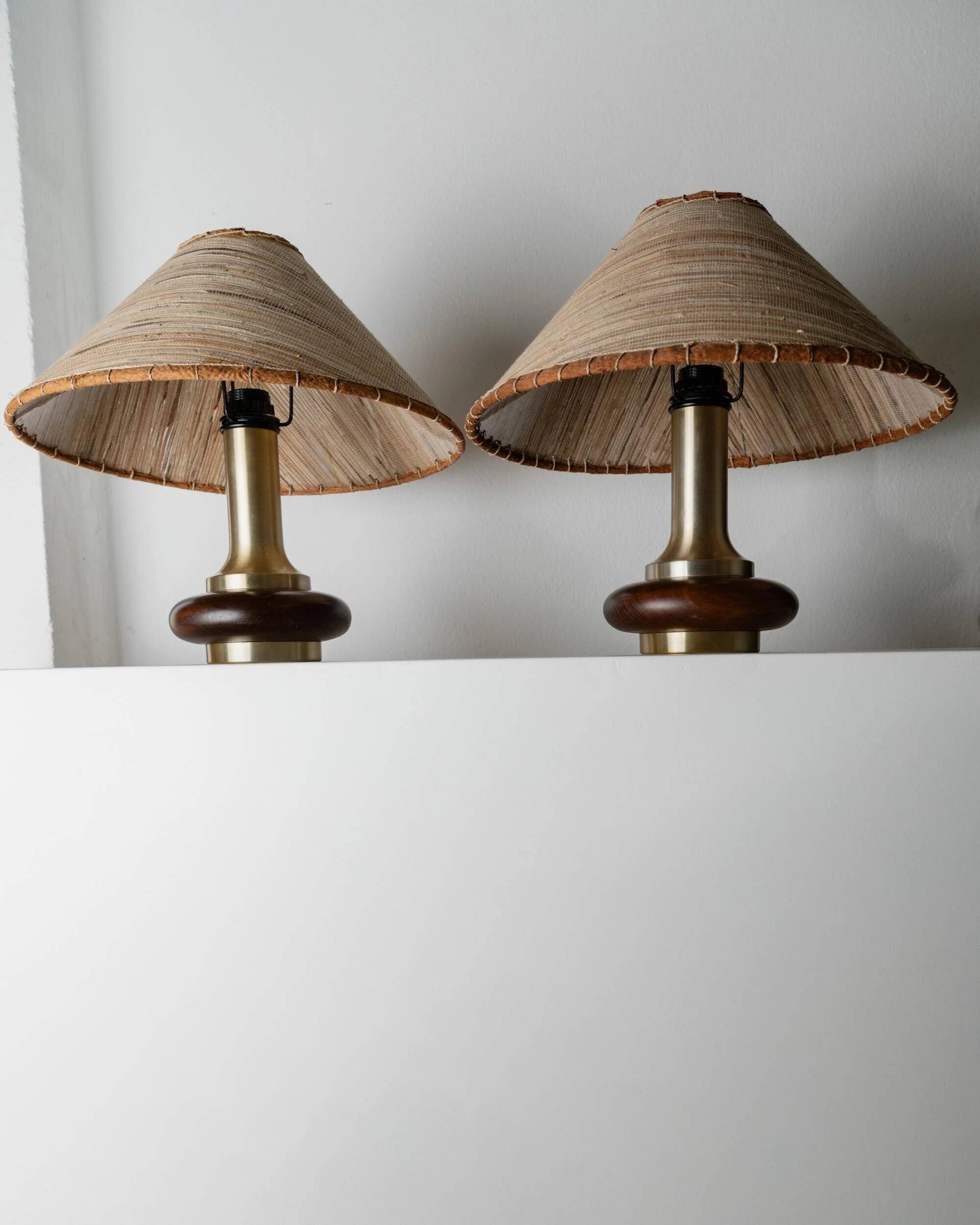 Lot of 2 vintage table lamps from the 1970s, dark wood oval bases with curved brass details, handmade natural fibre lampshades, elegant lighting.