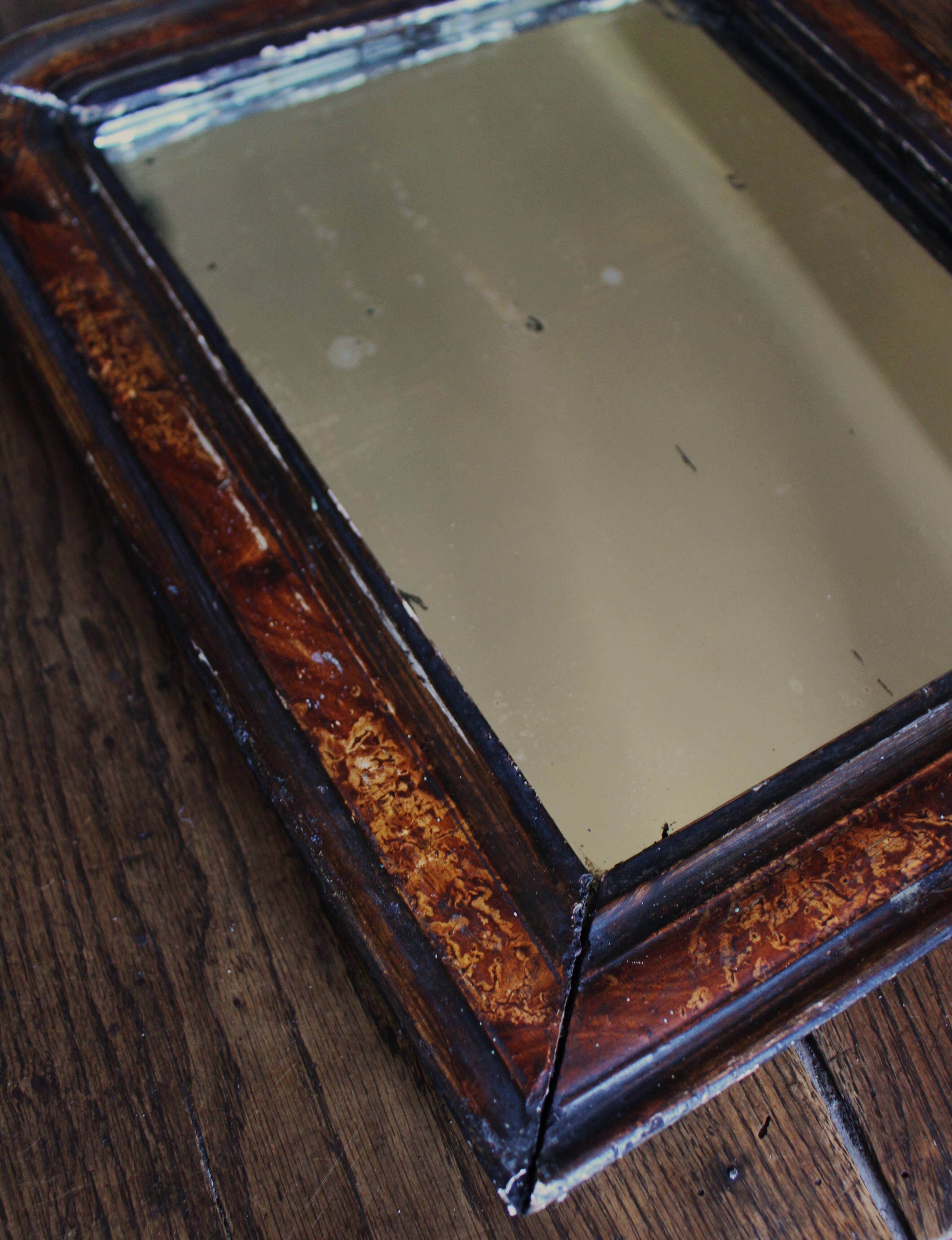 Antique Louis Philippe mirror in black and brown.