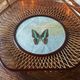 Rattan basket/tray/coin tray with a collection butterfly.