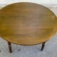 Extendable round table in solid wood with a dark oak satin finish.