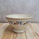 Old ironstone bowl with vintage blue and ochre decoration.