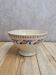 Old ironstone bowl with vintage blue and ochre decoration.