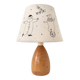 Wood-turned lamp with a hand-drawn lampshade, circus patterns.