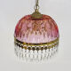 Vintage rose pendant light with pendants and patterned glass globe.