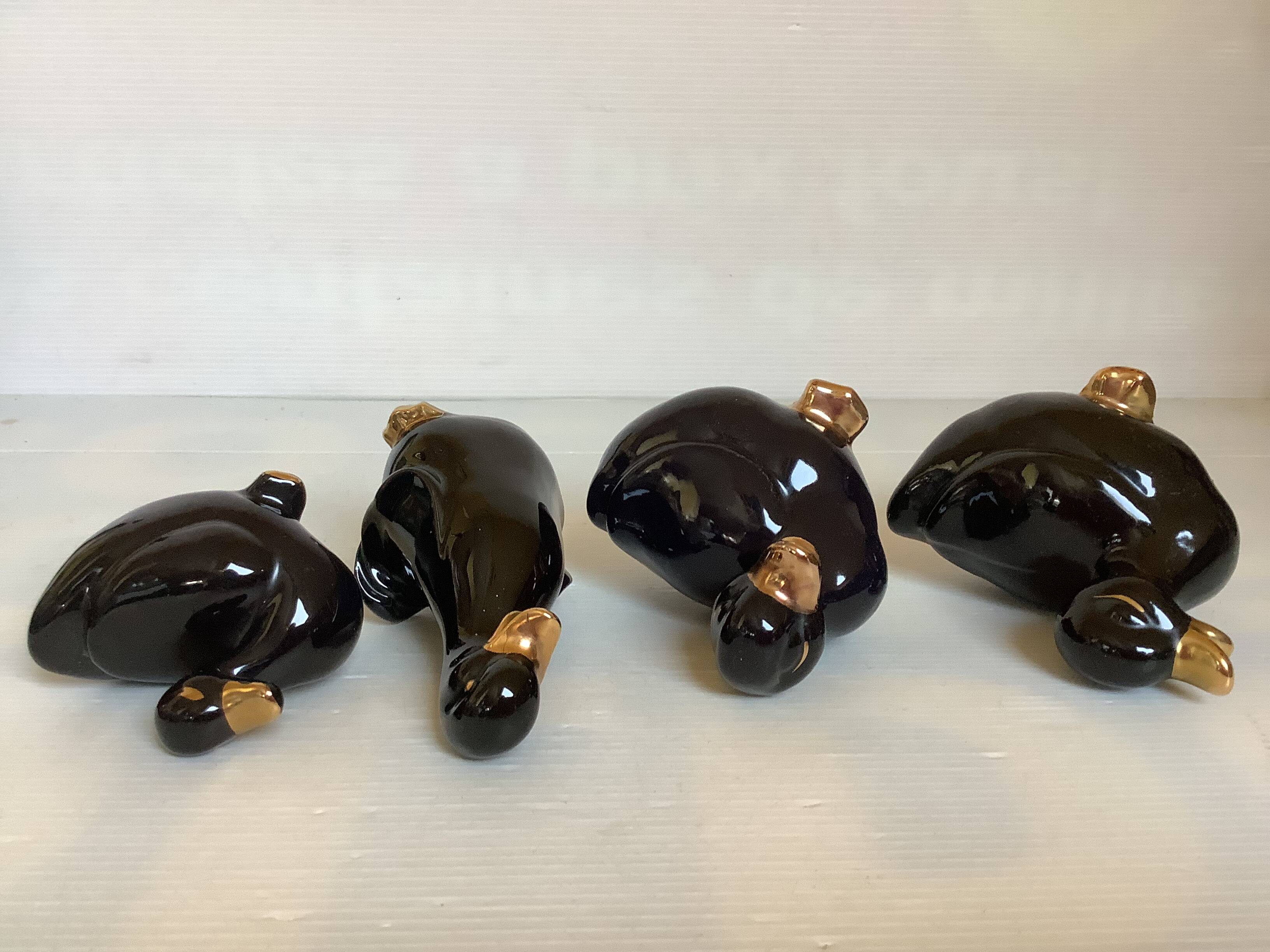 Four little black and golden ducks.