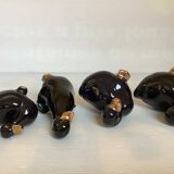 Four little black and golden ducks.