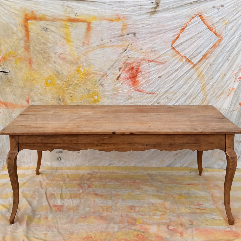 Curved farmhouse table in rustic wood, Provençal style.