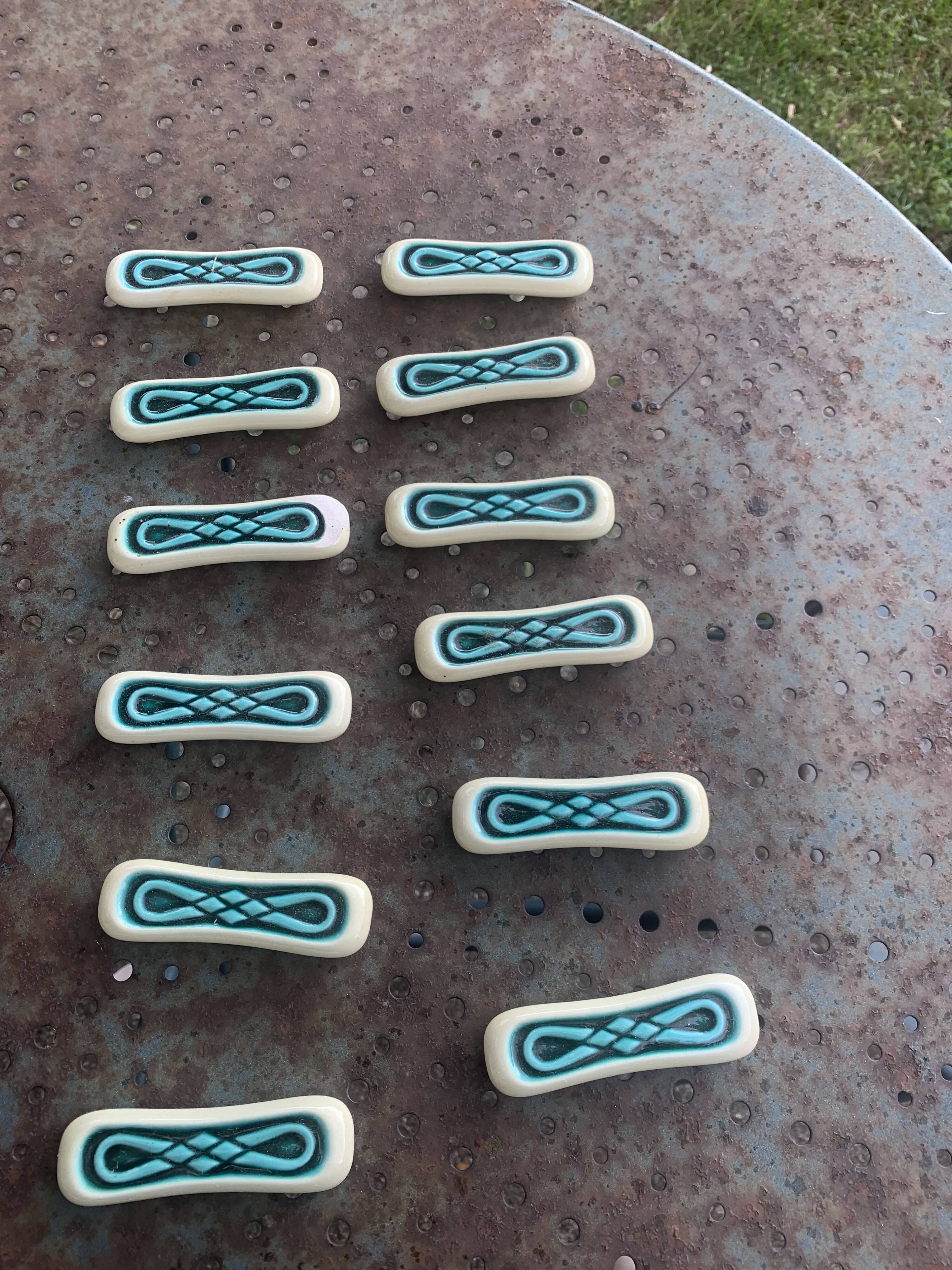 Set of 12 knife holders in green and beige glazed ceramic, slip,