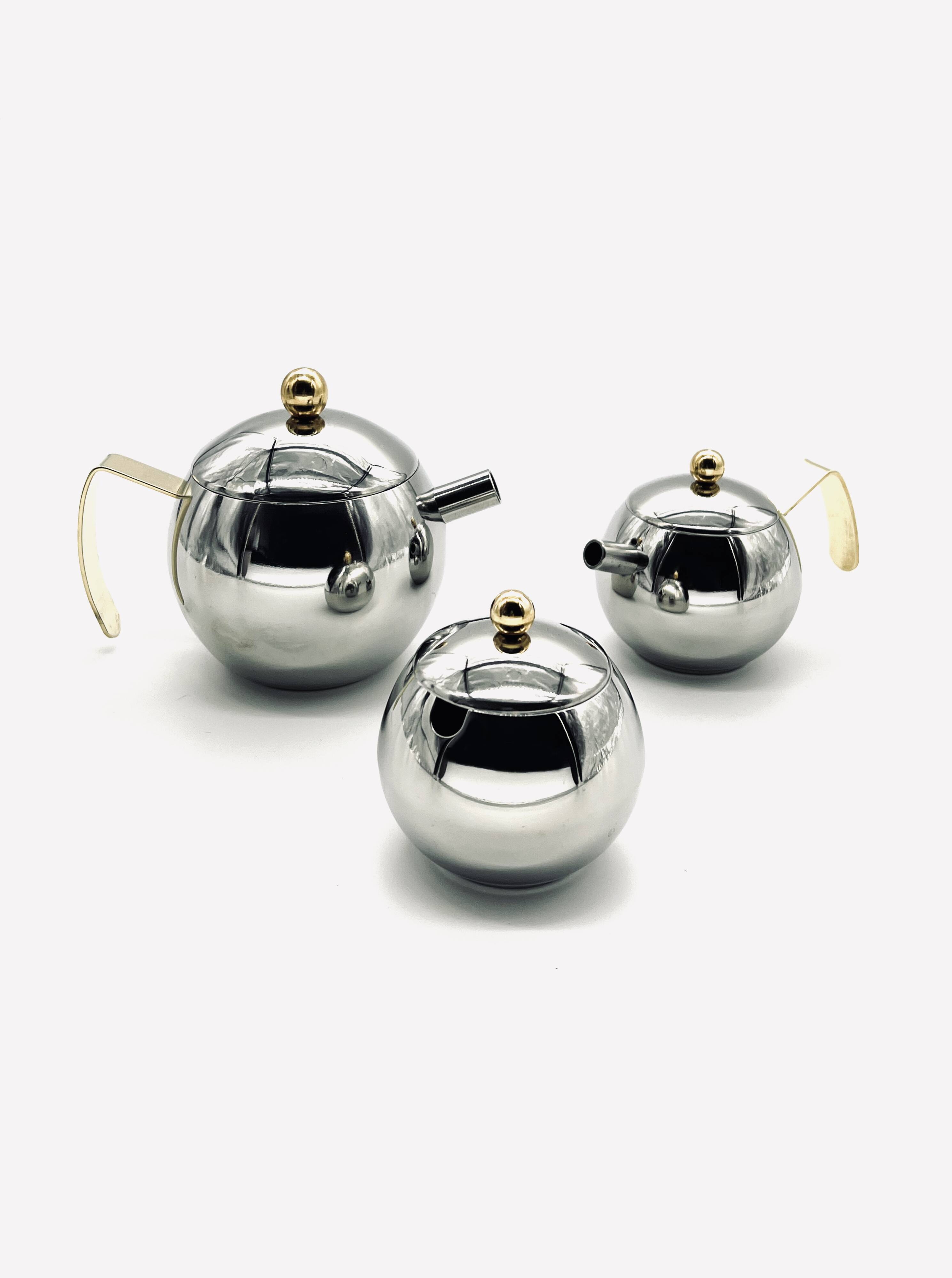 Stainless steel teapot, milk jug and sugar bowl