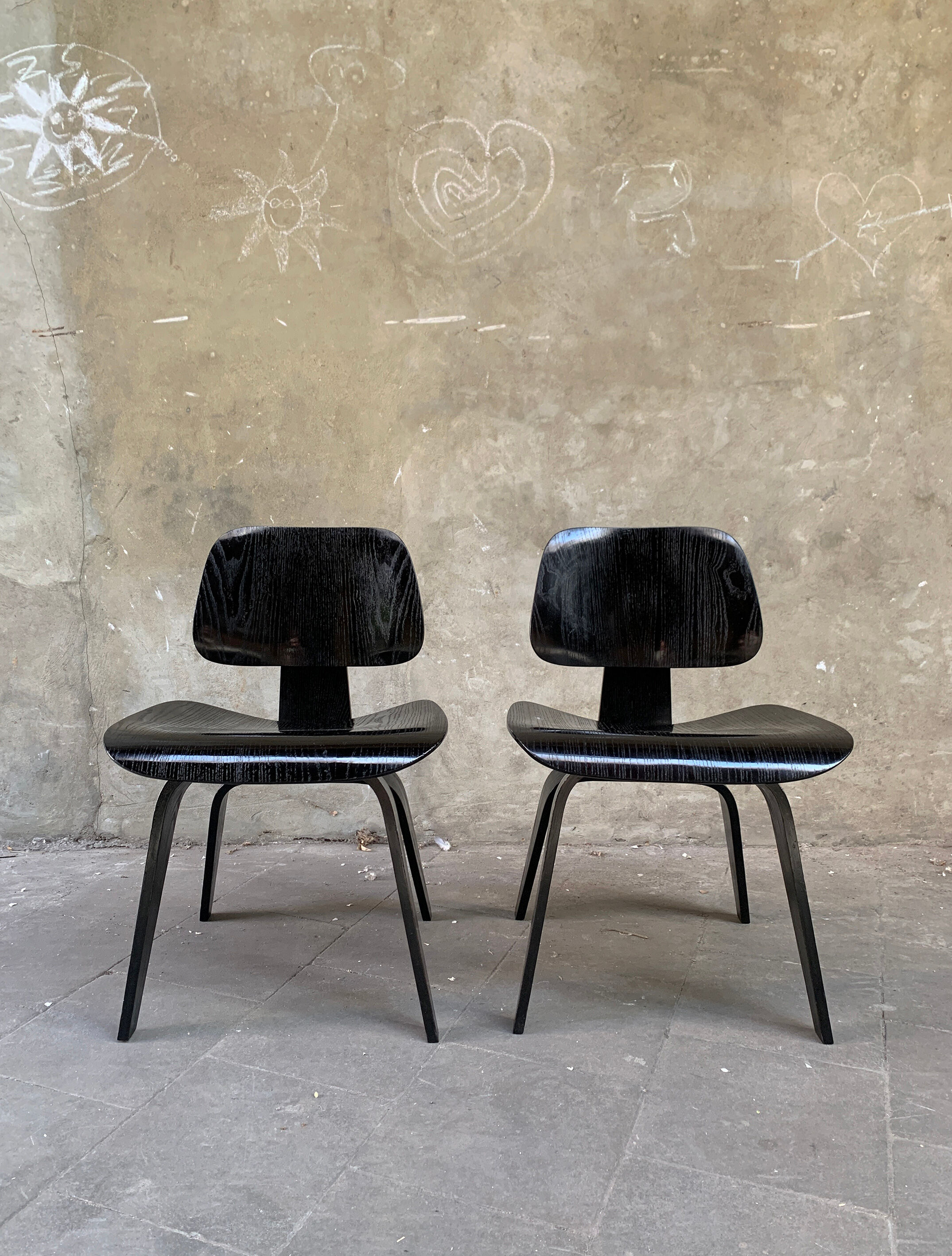 Pair of DCW chairs by Charles & Ray Eames in Black for Herman Miller 1950