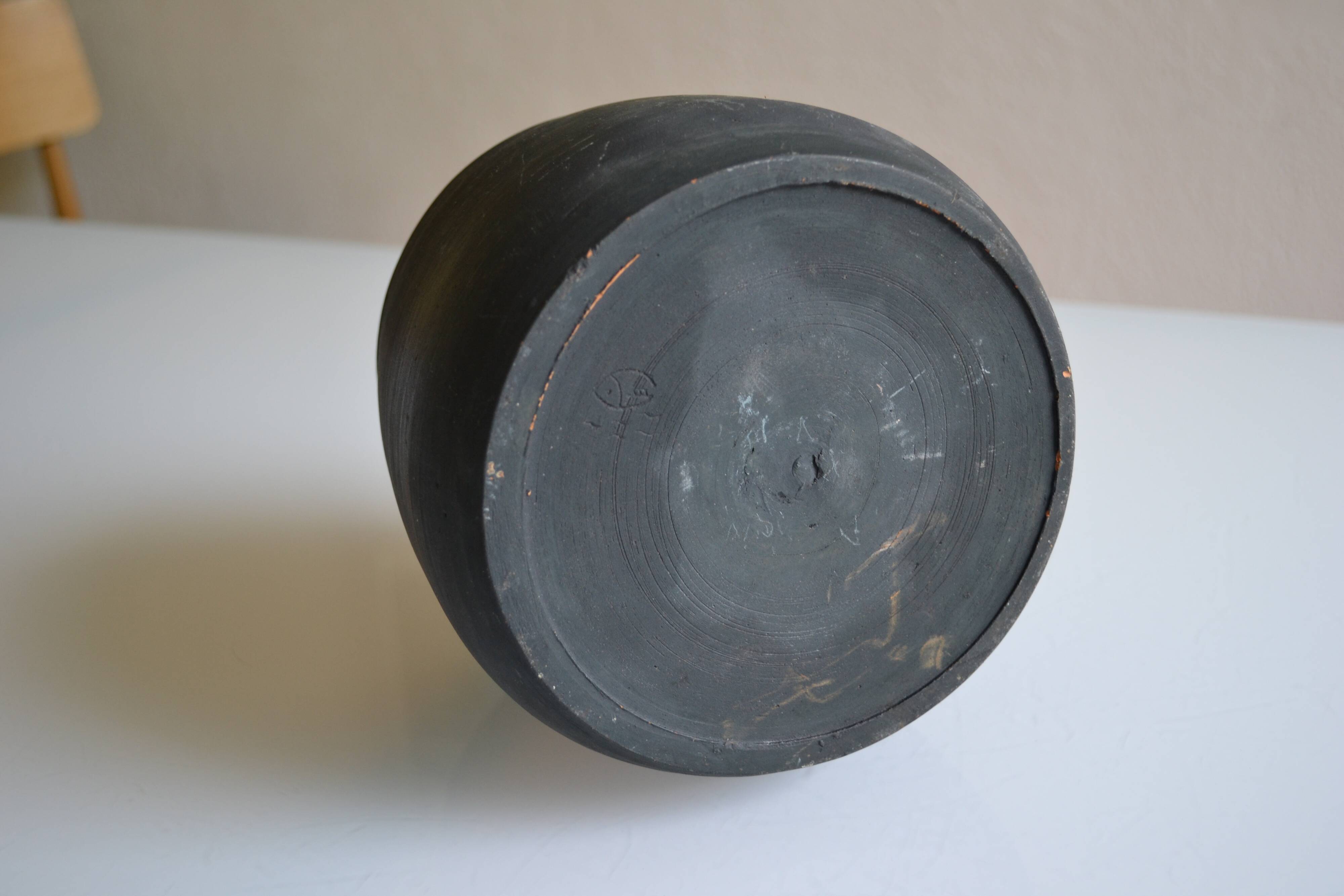 Ceramic cache pot or pocket emptying dish with a signature fish to identify.