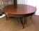 Important central pedestal table in mahogany, brass and bronze that can form a large dining table.