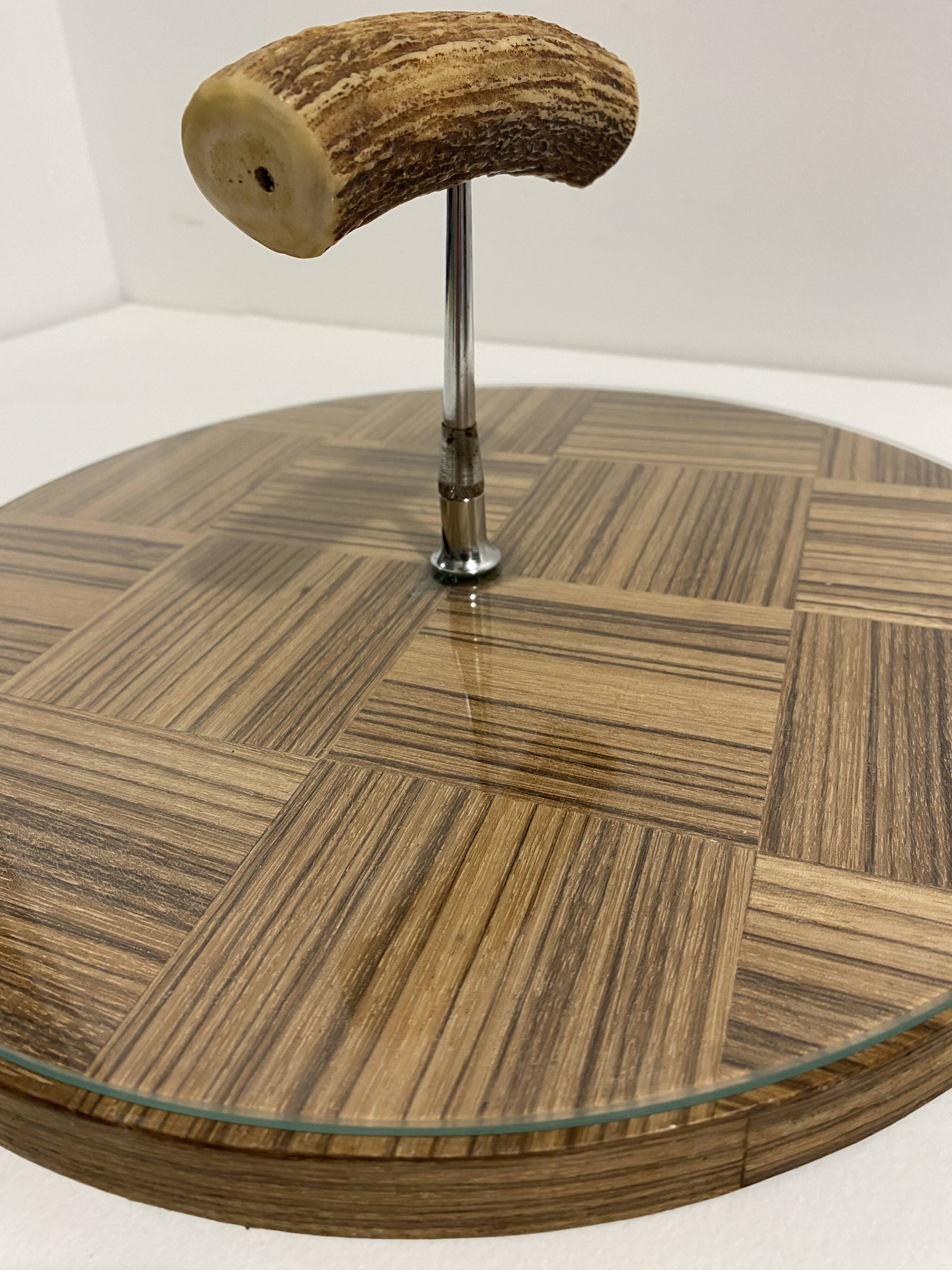 Vintage round wooden cheese board covered with glass plate with foldable handle